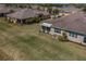 Aerial view of landscaped backyard, screened-in lanai, and beautifully maintained lawn at 2234 Nottingham Greens Dr # 2234, Sun City Center, FL 33573