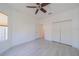 Bright bedroom featuring tile floors, ceiling fan, neutral paint and closet doors at 2234 Nottingham Greens Dr # 2234, Sun City Center, FL 33573