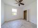 Bedroom with tile flooring, ceiling fan, window with blind, and closet with open doors at 2234 Nottingham Greens Dr # 2234, Sun City Center, FL 33573