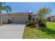 Charming single-story home features a well-manicured lawn, two-car garage, and decorative landscaping at 2234 Nottingham Greens Dr # 2234, Sun City Center, FL 33573