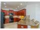 Well-appointed kitchen with granite countertops, wood cabinets, and a breakfast bar seating area at 2234 Nottingham Greens Dr # 2234, Sun City Center, FL 33573