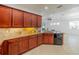 Spacious kitchen featuring granite countertops, wooden cabinets, tile flooring and stainless steel appliances at 2234 Nottingham Greens Dr # 2234, Sun City Center, FL 33573