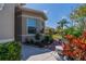 Beautiful landscaping with colorful plants, a brick walkway, and a cozy bench at 2234 Nottingham Greens Dr # 2234, Sun City Center, FL 33573