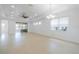 Expansive living area with tile floors, a ceiling fan, and natural light from windows at 2234 Nottingham Greens Dr # 2234, Sun City Center, FL 33573