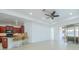 Spacious living area with tile flooring, ceiling fan, and an open flow to the sun room and kitchen at 2234 Nottingham Greens Dr # 2234, Sun City Center, FL 33573