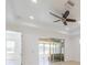 Bright living room features a tray ceiling, ceiling fan, and access to the sun room at 2234 Nottingham Greens Dr # 2234, Sun City Center, FL 33573