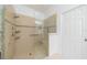 A modern shower with glass enclosure featuring a rainfall showerhead and built-in shelves and seating at 2234 Nottingham Greens Dr # 2234, Sun City Center, FL 33573