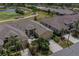 Birds-eye view of home and neighborhood, features a manicured lawn, screened patio, beige exterior, and close proximity to a golf course at 2286 Sifield Greens Way # 2286, Sun City Center, FL 33573