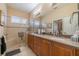 Bathroom boasts a large vanity with double sinks and a spacious walk-in shower with a glass door at 2286 Sifield Greens Way # 2286, Sun City Center, FL 33573