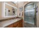 Bathroom featuring granite counters, updated mirror and glass shower at 2286 Sifield Greens Way # 2286, Sun City Center, FL 33573