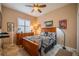 This bedroom has a ceiling fan, shuttered window, and wood furniture at 2286 Sifield Greens Way # 2286, Sun City Center, FL 33573
