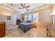 Comfortable bedroom featuring a ceiling fan, tray ceiling, and ample natural light at 2286 Sifield Greens Way # 2286, Sun City Center, FL 33573