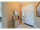 Inviting entryway features tile flooring, a decorative mirror, elegant decor, and a bright white front door with sidelight windows at 2286 Sifield Greens Way # 2286, Sun City Center, FL 33573