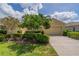 Well-maintained single-story home with lush landscaping, a manicured lawn, and a spacious two-car garage at 2286 Sifield Greens Way # 2286, Sun City Center, FL 33573