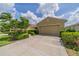 Beautiful single-story home with a manicured lawn, mature trees, and a two-car garage at 2286 Sifield Greens Way # 2286, Sun City Center, FL 33573