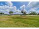 Scenic golf course view with lush green grass, stately palm trees, and neighborhood homes at 2286 Sifield Greens Way # 2286, Sun City Center, FL 33573