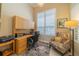 Bright home office with built-in desk, ample storage, and a comfortable sitting area at 2286 Sifield Greens Way # 2286, Sun City Center, FL 33573