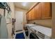 The spacious laundry room features newer front load washer and dryer and ample cabinet space at 2286 Sifield Greens Way # 2286, Sun City Center, FL 33573
