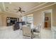 Inviting living room with comfortable seating, ceiling fan, and sliding doors to a screened lanai at 2286 Sifield Greens Way # 2286, Sun City Center, FL 33573