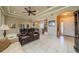 Open floor plan featuring a living room seamlessly connected to the kitchen, with tile floors, and comfortable seating arrangements at 2286 Sifield Greens Way # 2286, Sun City Center, FL 33573