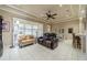 Spacious living room includes tile floors, modern tray ceilings, plantation shutters, and cozy furniture, perfect for relaxation and entertainment at 2286 Sifield Greens Way # 2286, Sun City Center, FL 33573