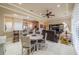 Open concept living and dining area boasts tile flooring, tray ceilings, ceiling fan, comfortable seating, and a breakfast bar at 2286 Sifield Greens Way # 2286, Sun City Center, FL 33573