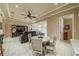 Spacious living area with tile floors, tray ceilings, ceiling fan, comfortable seating, and seamless connection to other living areas at 2286 Sifield Greens Way # 2286, Sun City Center, FL 33573