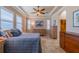Serene main bedroom with tray ceilings, plantation shutters, and a view of the walk-in closet at 2286 Sifield Greens Way # 2286, Sun City Center, FL 33573