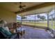 This home features a covered patio with ceiling fan and a view of the golf course at 2286 Sifield Greens Way # 2286, Sun City Center, FL 33573