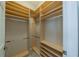 Spacious walk-in closet with shelving and hanging rods for optimal storage at 2286 Sifield Greens Way # 2286, Sun City Center, FL 33573