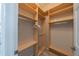 Organized walk-in closet featuring shelving and hanging space for efficient storage at 2286 Sifield Greens Way # 2286, Sun City Center, FL 33573