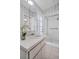 Bathroom featuring a white vanity, floral wallpaper and tiled shower stall at 2462 Indian E Trl, Palm Harbor, FL 34683