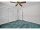 Neutral bedroom with closet and door, and ceiling fan at 2462 Indian E Trl, Palm Harbor, FL 34683