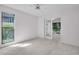Inviting bedroom features large window and glass doors to the patio at 2462 Indian E Trl, Palm Harbor, FL 34683