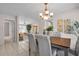 Dining room showcasing chandelier lighting, tile floor, and access to living room at 2462 Indian E Trl, Palm Harbor, FL 34683