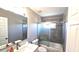 Bathroom featuring a modern vanity, toilet, and shower with gray tiled walls at 25631 Bruford Blvd, Land O Lakes, FL 34639