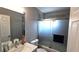 Neutral-toned bathroom featuring a marble sink and shower with sliding glass doors at 25631 Bruford Blvd, Land O Lakes, FL 34639