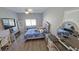 Calm bedroom boasts a comfortable bed, desk, TV, and stylish decor for a relaxing retreat at 25631 Bruford Blvd, Land O Lakes, FL 34639