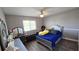 Comfortable bedroom featuring a window and ceiling fan, complete with a bed and vanity at 25631 Bruford Blvd, Land O Lakes, FL 34639