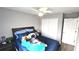Bedroom with hardwood floors, a fan, a double door closet, and a comfortable bed at 25631 Bruford Blvd, Land O Lakes, FL 34639