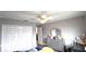 Bright bedroom with a ceiling fan, a dresser, and a closet for ample storage at 25631 Bruford Blvd, Land O Lakes, FL 34639