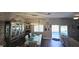 Open-concept dining area leading to a patio and pool, with stylish furnishings and lighting at 25631 Bruford Blvd, Land O Lakes, FL 34639