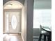 Welcoming entryway featuring a decorative glass door, neutral walls, and wood-look floors with archway access at 25631 Bruford Blvd, Land O Lakes, FL 34639