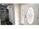 Bright entryway with decorative glass door, coat rack, and stylish decor at 25631 Bruford Blvd, Land O Lakes, FL 34639