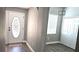 Welcoming foyer with decorative glass front door and wood-look floors at 25631 Bruford Blvd, Land O Lakes, FL 34639