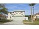 Two-story home with a two-car garage, well-maintained lawn, and classic curb appeal at 25631 Bruford Blvd, Land O Lakes, FL 34639