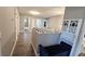 Second floor hallway featuring wood flooring, a sitting area, and access to bedrooms at 25631 Bruford Blvd, Land O Lakes, FL 34639