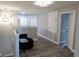 Second floor hallway featuring wood flooring, a sitting area, and access to bedrooms at 25631 Bruford Blvd, Land O Lakes, FL 34639