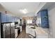 Charming kitchen with blue cabinetry, modern stainless steel appliances, and elegant countertops at 25631 Bruford Blvd, Land O Lakes, FL 34639