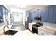 Cozy kitchen with stainless steel appliances, white countertops, and light blue upper and white lower cabinets at 25631 Bruford Blvd, Land O Lakes, FL 34639